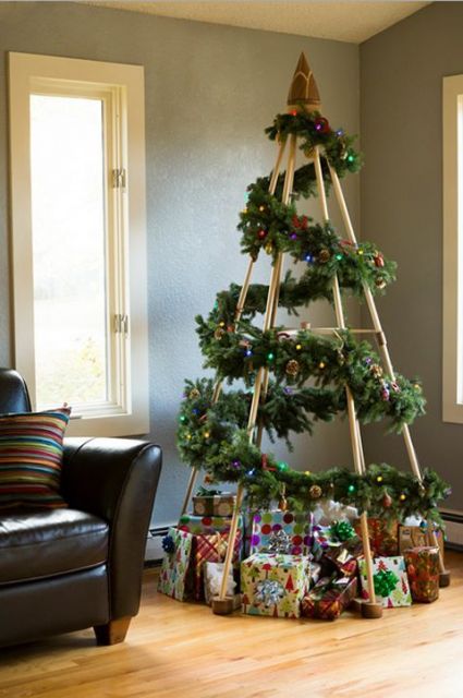 árvore de Natal com estrutura de madeira com ramos decorativos ao redor