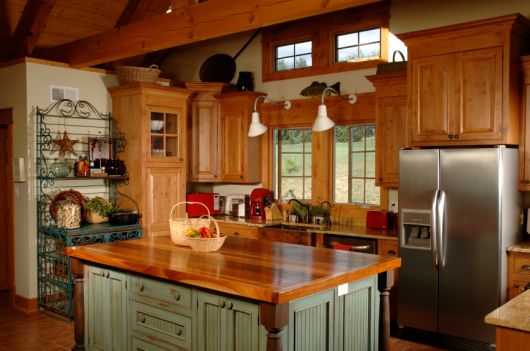 Cozinha rústica nas cores verde e madeira marrom envernizada.