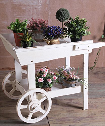 Modelo de carrinho de chá na cor branca com roda, decorado com plantinhas.
