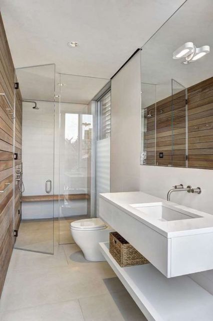 Foto de um lavabo com uma bancada simples e torneira de parede feita de metal com duas aberturas. 