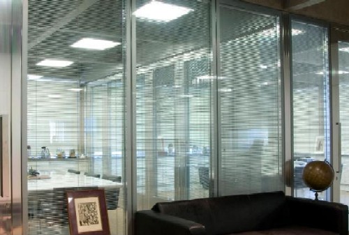 Divisória de vidro para escritório com persiana.