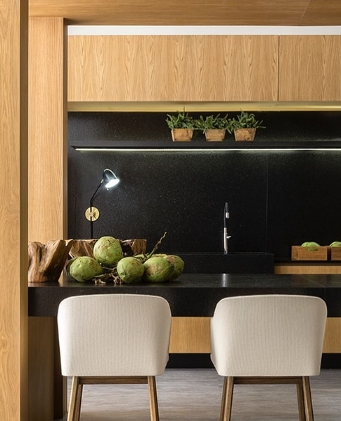 cozinha com armários de madeira e granito preto escovado