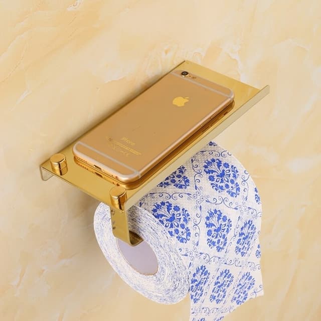 porta papel higienico dourado com suporte para celular